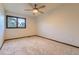This bedroom features a ceiling fan, neutral carpeting, a window and warm-tone trim at 5723 S Kittredge St, Centennial, CO 80015