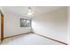 A bright bedroom features a ceiling fan, carpet and a window at 5723 S Kittredge St, Centennial, CO 80015