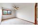 Cozy bedroom with a ceiling fan, carpet flooring, and natural light from a window at 5723 S Kittredge St, Centennial, CO 80015