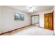 Bright bedroom featuring a ceiling fan, window with nature view and a mirrored closet at 5723 S Kittredge St, Centennial, CO 80015