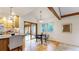 Bright kitchen and dining area with hardwood floors, vaulted ceilings, and modern furnishings at 5723 S Kittredge St, Centennial, CO 80015