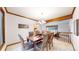 Dining room with wood table, chairs, and a beam, connecting to the living room at 5723 S Kittredge St, Centennial, CO 80015
