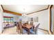 Dining room with wood table, chairs, beam, and connection to the upper level at 5723 S Kittredge St, Centennial, CO 80015