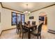 Cozy dining room boasting natural light, a wooden table, and a view into the updated kitchen at 5723 S Kittredge St, Centennial, CO 80015