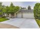 Charming brick home with a three-car garage and a well-manicured lawn at 5723 S Kittredge St, Centennial, CO 80015