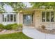 Inviting front porch with a double-door entrance, decorative landscaping, and a charming bay window at 5723 S Kittredge St, Centennial, CO 80015