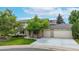 Charming two-story home with a well-manicured lawn and mature trees adding curb appeal at 5723 S Kittredge St, Centennial, CO 80015