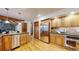 Bright kitchen featuring wood cabinetry, stone backsplash, and stainless steel appliances at 5723 S Kittredge St, Centennial, CO 80015