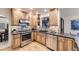 Well-equipped kitchen featuring custom wood cabinets, stainless steel appliances, and granite countertops at 5723 S Kittredge St, Centennial, CO 80015