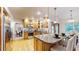 Spacious kitchen with stainless steel appliances, bar stool seating, and hardwood flooring at 5723 S Kittredge St, Centennial, CO 80015