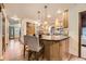 Kitchen view with island seating, stainless appliances, wood cabinets, and hardwood floors at 5723 S Kittredge St, Centennial, CO 80015
