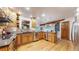 Well-lit kitchen with stainless steel appliances, hardwood floors, and dark countertop at 5723 S Kittredge St, Centennial, CO 80015