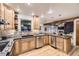 Spacious kitchen featuring stainless steel appliances, wood cabinets, dark countertops and recessed lighting at 5723 S Kittredge St, Centennial, CO 80015