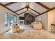 Spacious living room with vaulted ceilings, stone fireplace, and natural light, perfect for relaxing and entertaining at 5723 S Kittredge St, Centennial, CO 80015