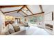 Spacious living room with vaulted ceilings, exposed beams, and access to the backyard patio at 5723 S Kittredge St, Centennial, CO 80015