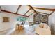 Inviting living room with vaulted ceilings, exposed beams, fireplace, and cozy seating at 5723 S Kittredge St, Centennial, CO 80015