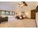Spacious main bedroom featuring a high ceiling, large windows, and a comfortable seating area at 5723 S Kittredge St, Centennial, CO 80015