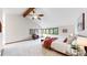 Vaulted ceiling bedroom with windows, chair, ceiling fan, and bed with light neutral colors at 5723 S Kittredge St, Centennial, CO 80015