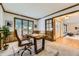 Bright home office with desk, chair, wood trim, and large window views to the front yard at 5723 S Kittredge St, Centennial, CO 80015
