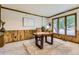 Inviting home office space with wood accents, carpeted floors, and bright natural light from large windows at 5723 S Kittredge St, Centennial, CO 80015