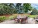 Outdoor patio with brick flooring, patio table with chairs, and lush landscaping at 5723 S Kittredge St, Centennial, CO 80015
