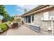 Outdoor patio with brick flooring, awning, patio table and lush landscaping at 5723 S Kittredge St, Centennial, CO 80015