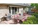 Exterior view of home featuring brick facade, patio table and a grill at 5723 S Kittredge St, Centennial, CO 80015