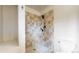 Updated shower stall features tan tile and modern fixtures at 5723 S Kittredge St, Centennial, CO 80015