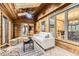 Bright sunroom featuring wood-paneled walls and ceiling, tile floors, and modern furniture at 5723 S Kittredge St, Centennial, CO 80015