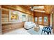 Inviting sunroom features wood paneling, tile flooring, and floods of natural light from large windows and skylights at 5723 S Kittredge St, Centennial, CO 80015