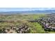 Panoramic aerial view showcasing a stunning landscape with rolling hills, mature trees, and surrounding mountains at 2154 S Parfet Dr, Lakewood, CO 80227