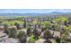 Breathtaking aerial view of a neighborhood with lush greenery, mature trees, and picturesque mountain backdrop at 2154 S Parfet Dr, Lakewood, CO 80227