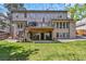 Expansive backyard featuring a lush lawn, mature trees, a patio, and upper deck; perfect for outdoor living and entertaining at 2154 S Parfet Dr, Lakewood, CO 80227