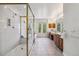 Bright bathroom featuring a glass enclosed shower, soaking tub, double vanity, and neutral tile flooring at 2154 S Parfet Dr, Lakewood, CO 80227