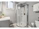 Bathroom featuring a corner glass shower, tile flooring, and neutral paint at 2154 S Parfet Dr, Lakewood, CO 80227