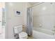This bathroom features a tiled shower/bathtub combination and natural light at 2154 S Parfet Dr, Lakewood, CO 80227