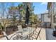 View of a deck with outdoor furniture and trees behind at 2154 S Parfet Dr, Lakewood, CO 80227