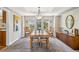 Bright dining room with large windows and a wood table at 2154 S Parfet Dr, Lakewood, CO 80227