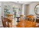 Dining room with a wood table set for six guests and large windows at 2154 S Parfet Dr, Lakewood, CO 80227