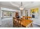 Open-concept dining room with hardwood table and view of the living room at 2154 S Parfet Dr, Lakewood, CO 80227