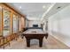 Spacious game room featuring a pool table, comfortable seating, and wood paneled walls at 2154 S Parfet Dr, Lakewood, CO 80227
