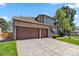 A home with a spacious garage and large concrete driveway at 2154 S Parfet Dr, Lakewood, CO 80227