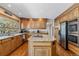 Traditional kitchen with wood cabinets, granite countertops, and stainless steel appliances at 2154 S Parfet Dr, Lakewood, CO 80227