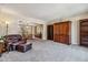 Living room with a leather couch, bookcase, and open dining area at 2154 S Parfet Dr, Lakewood, CO 80227