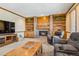 Comfortable living room with a brick fireplace and built-in bookshelves at 2154 S Parfet Dr, Lakewood, CO 80227