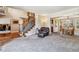 Open-concept living area with a staircase and dining room access at 2154 S Parfet Dr, Lakewood, CO 80227