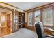 Home office with wood trim, built-in bookshelves, and natural light at 2154 S Parfet Dr, Lakewood, CO 80227