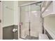 Bathroom featuring a shower with a glass door, and integrated shelving units at 8345 Moore St, Arvada, CO 80005