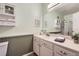 Neutral bathroom with wainscoting, a large vanity, and ample storage shelves at 8345 Moore St, Arvada, CO 80005