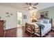 Bright bedroom with a wooden ceiling fan, wood floors, and vintage-style bedframe at 8345 Moore St, Arvada, CO 80005